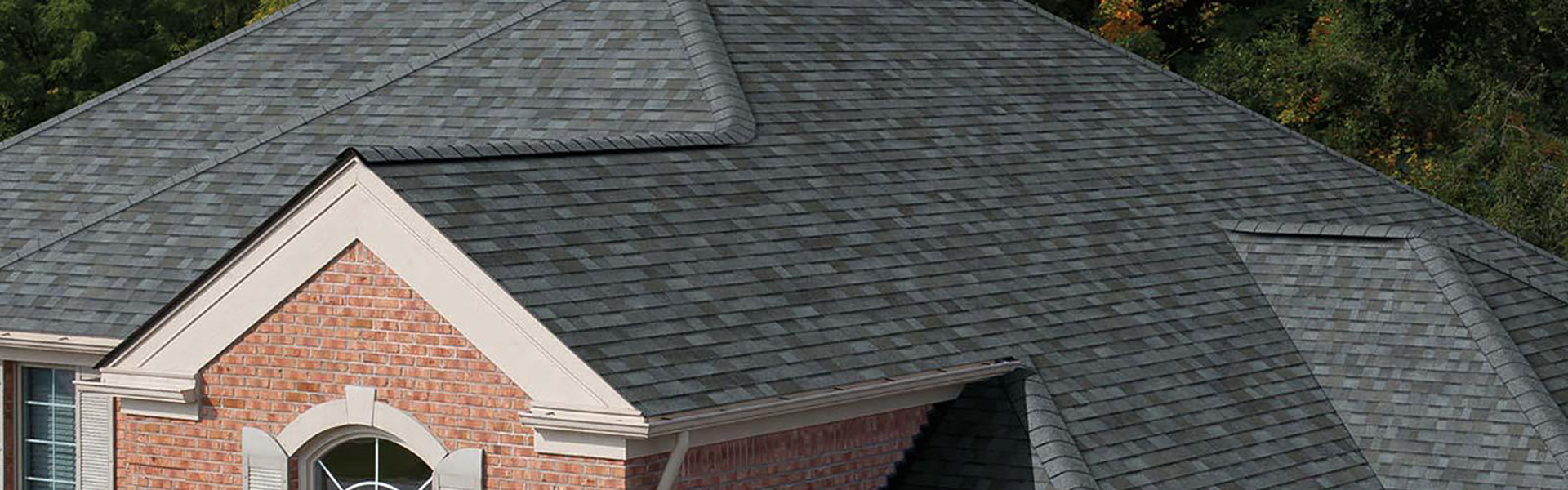 Large residential roof with a dark gray shingle roof